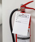 One Thousand Heavy Duty Bulk Diamond Tag Fasteners For Fire Extinguisher Inspection Tags With Secure Metal Clips holding inspection tag on extinguisher.