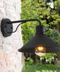Matte black barn-style outdoor wall light, mounted on brick wall, part of 3 Pack Outdoor Wall Lights Wall Mount For Front Porch.