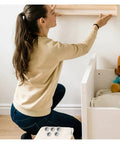 Woman assembling furniture using Cam Lock Pins Kit 10 Pcs Furniture Connecting Brackets for Cabinets and Wardrobes.