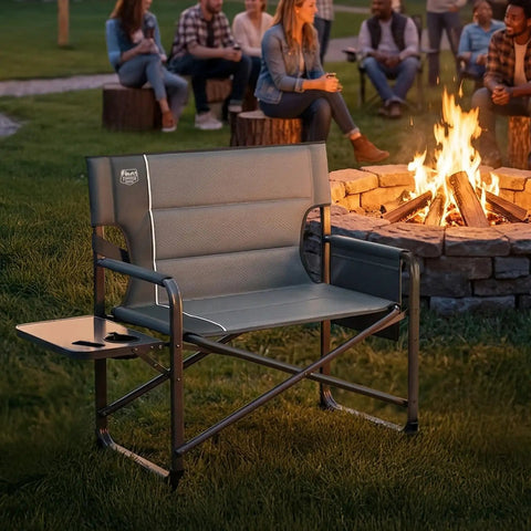Beefy Heavy Duty XXL Director's Chair With Extra Wide 32 Inch Seat And 500 Lb Capacity, Padded Comfort Armrests beside campfire