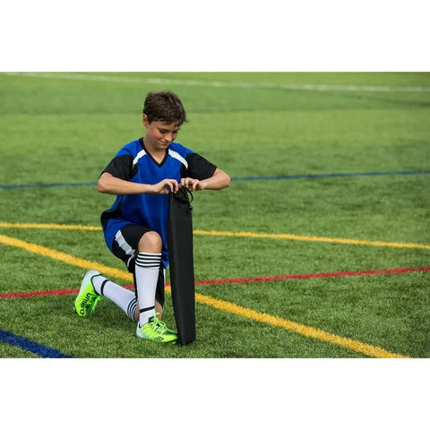 Child setting up Portable Backyard Soccer Goal Small Size Pop Up With Quick Setup Durable Fiberglass Frame All Weather Practice Net
