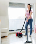 Person using a red vacuum on wooden floor with 8 Pack Style C And Q Canister Vacuum Bags Replacement For Kenmore 50104 5055 50557 50558 Type C 5