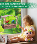 Child observing Metal Window Bird Feeder With Wide Viewing Window And Ultra Strong Suction Cups For Easy Mount On Glass
