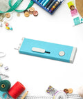 Automatic Needle Threader With Seam Unpicker For Home Sewing Machines Easy Threading Tool For Beginners And Novices No-Fuss Quick Threading Smooth Sewing Sessions Makes Needle Changes Fast And Simple, blue retractable plastic tool on craft table
