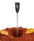 2-In-1 Soil Moisture Meter And PH Tester With A 12 Inch Probe inserted in soil, showing durable weather resistant build for plant care
