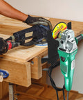 Worker using a 4 Pack Angle Grinder Holder Wall Mount Bracket For 5 Inch Grinders Polisher Storage Rack Stand with cord hook on workbench.