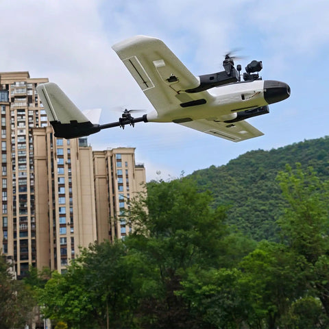 ZOHD Altus 980mm Wingspan Twin Motor V Tail EPP FPV RC Airplane flying outdoors, buildings and trees in the background