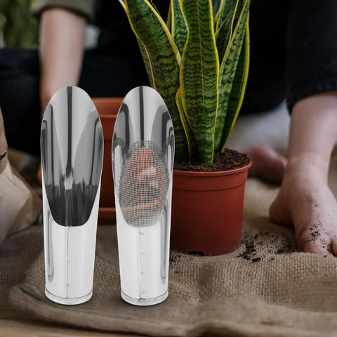 Two Piece Stainless Steel Garden Shovel And Soil Sifter Set next to a potted plant on burlap with blurred background garden scene
