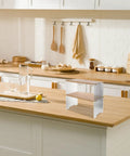 Clear The Counter Clutter With This Slick Wooden Acrylic Display Shelf on a kitchen countertop, showcasing its tiered design.