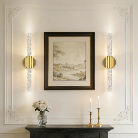 Elegant room with Battery Operated Wall Sconces Set Of 2 In Gold next to framed artwork on a white wall.
