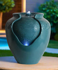 Teal Glazed Pot Water Fountain With Built In Led Light And Pump For Outdoor And Indoor Use on a patio