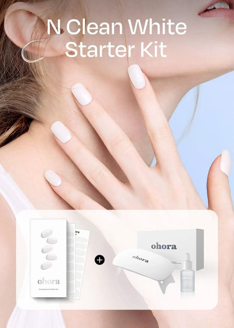 Woman wearing white solid gel nail strips with UV LED lamp and starter kit box, labeled N Clean White Starter Kit, visible.