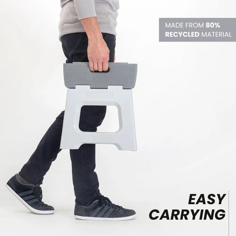 Person carrying Compact Foldable Step Stool for Adults Up to 330 Pounds, Lightweight Non Slip Gray Stool, Easy Fold design