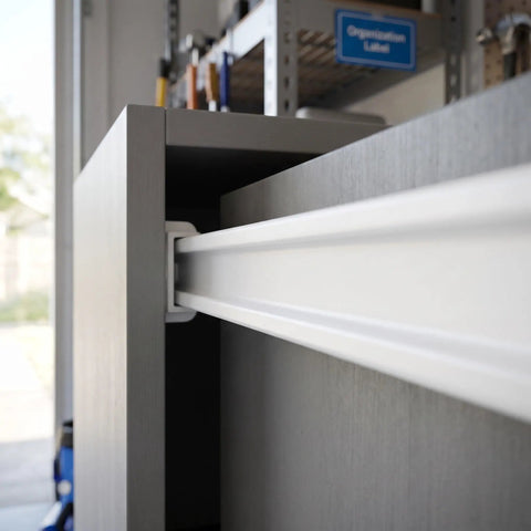 Close-up of Six Piece White ABS Bottom Mount Drawer Slides Slick As Grease Cabinet Guide Rails for easy drawer operation.