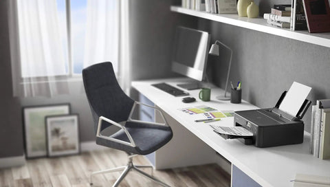 PIXMA TS702a Wireless Single Function Printer With AirPrint And Mopria For Easy Mobile Printing Black Energy Star Certified Fast 10 IPM Black Print Speed Beast For Your Home Office Setup Includes Tray And Photo Paper Pack 1 Year Warranty on a desk in a modern home office.