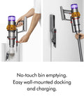 V15 Detect Cordless Vacuum Cleaner with Smart Dust Detection and Power Trigger in use, showing bin emptying and wall-mounted docking