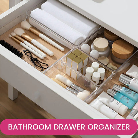 Open drawer showing Big 26 Pack Drawer Organizer Bins In Clear Plastic, multiple cosmetics and toiletries arranged neatly inside bins.