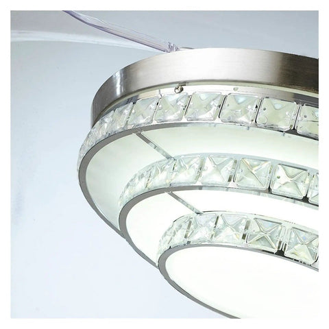 Close-up of 42 Inch Retractable Blade Ceiling Fan Featuring Glowing Crystal Chandelier and Smart Remote Controls.