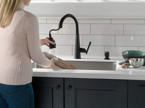 Woman using Emmeline Matte Black Metal Soap Dispenser 13 Oz Bottle, Refillable From Above The Deck, Fits One Three Eighths Inch Hole
