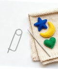 20pcs Stainless Steel Brooch Shape Cotter Pins Quick Lock Spring Safety Fasteners on fabric with felt shapes and crochet hook.