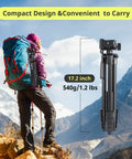 Hiker with compact 64 Inch Phone And Tablet Tripod Stand With Wireless Remote And 2 In 1 Phone Holder for travel in mountains