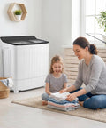 Compact Twin Tub Portable Washing Machine Featuring High Speed Drain Pump Quick Spin Dryer Combo in home setting with mother and child.