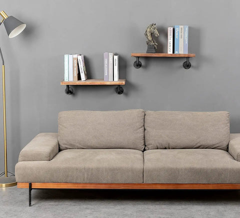 Living room with floating shelves supported by Beefy Wall Hanging Shelf Brackets Set Of 6 Heavy Duty Rustic Black Metal Pipe Brackets.