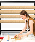 Woman organizing on table with adjustable hanging rod bracket floor to ceiling display rack for quilting fabric storage in background