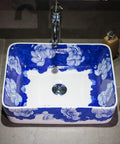 Top Shelf Rectangular Ceramic Vessel Sink With Slick Hand Painted Blue Finish For Above Counter Vanity Setup, showcasing floral design.