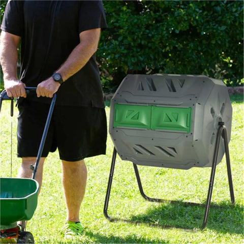 43 Gallon Dual Chamber Compost Tumbler With 360 Degree Rotation And 16 Aeration Vents on lawn next to gardener with cart