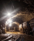 100 Ft LED Construction String Lights With 10 Bulbs On E26 Sockets, 100W Total, illuminating a mining tunnel with carts