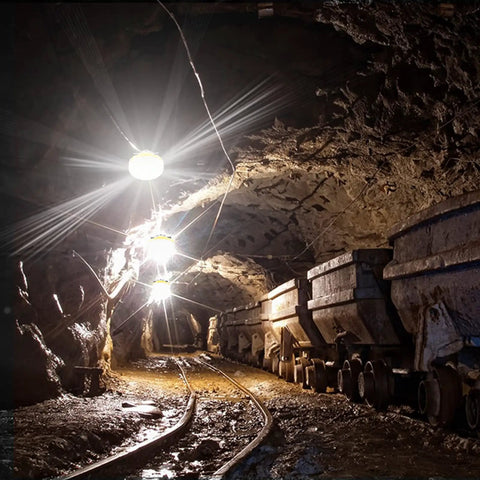 100 Ft LED Construction String Lights With 10 Bulbs On E26 Sockets, 100W Total, illuminating a mining tunnel with carts
