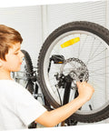 Child adjusting the Premium Aluminum Mechanical Disc Brake Kit For Mountain Bikes With Dual Knob Calipers and Full Front Rear Rotor Set.