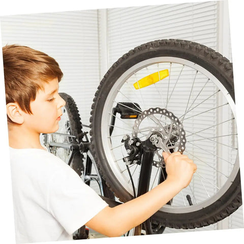 Child adjusting the Premium Aluminum Mechanical Disc Brake Kit For Mountain Bikes With Dual Knob Calipers and Full Front Rear Rotor Set.