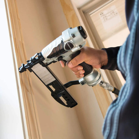 Person using narrow crown stapler for 18 gauge, half inch to one and a half inch staples, quarter inch crown on trim work