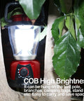 Battery Powered LED Lantern With Variable Power For Camping Dimmable COB LED Light hung in tree, red, outdoors