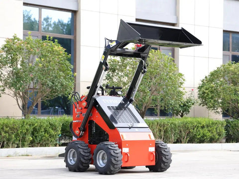 Compact Mini Skid Steer Loader with wide bucket, ideal for gardens, farms, and small jobs, 1800 lb capacity, parked outdoors