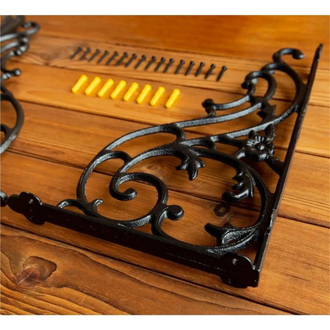 Certified Knockout Vintage Cast Iron Shelf Brackets For Heavy Duty Wood Floating Shelves and Ornate Wall Mounted Display Supports laying on wood.