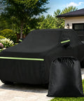 Hella Durable Oxford Pickup Truck Cover Compatible With Tesla Cybertruck 2024 Through 2026, black exterior with storage bag visible.
