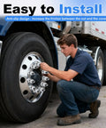 Man installing 33mm ABS Chrome Lug Nut Covers For Semi Trucks 20 Pack Push On Anti Rust Caps on a truck wheel