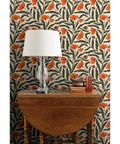 Botanical Chintz Vinyl Wallpaper Featuring Subtle Leather Texture Hella Durable Commercial Grade Wallcovering Custom Printed Just For You, showcasing vibrant floral design behind a table lamp.