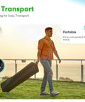 Man carrying a wheeled bag with the 10x20 Pop Up Screened Canopy Tent With Mosquito Netting for easy transport.