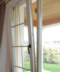 Tilted interior glass door with black handle, view from inside, suitable for keyed lever interior door handle with lock zinc alloy durable construction.