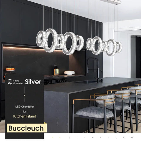 Five Ring Crystal Chandelier Pendant Light With Height Adjustable Stainless Steel Frame Dope K9 Crystals UL Certified Dimmable LED 6000K 4400lm For Dining Room Living Room Bedroom, hanging over modern kitchen island with stools.