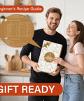 Couple in kitchen holding cookbook gift box labeled 'Beginner's Recipe Guide' with recipe text and 'Gift Ready' banner.