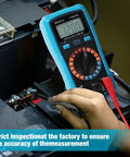 Person using digital multimeter to measure voltage on a battery.