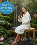 Woman seated on SnazzyCorner Waterproof Teak Shower Bench in garden setting