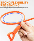 Hand holding a flexible 20 inch polypropylene drain snake, showcasing strong flexibility for stubborn pipe clogs and hair buildup.