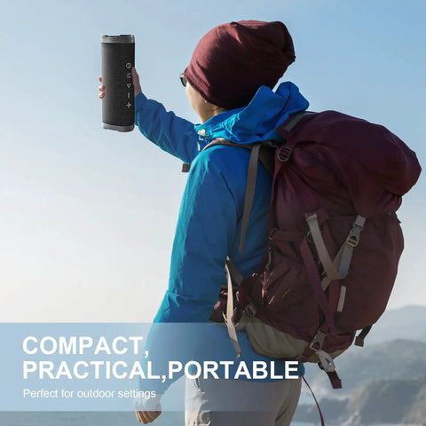 Hiker holding compact wireless Bluetooth speaker with 24W stereo sound, IPX7 waterproof, for outdoor adventures.