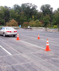 Car maneuvering between 10 Pack 28 Inch Safety Traffic Cones With Reflective Collar For Day And Night Visibility Orange Heavy Duty PVC Cones